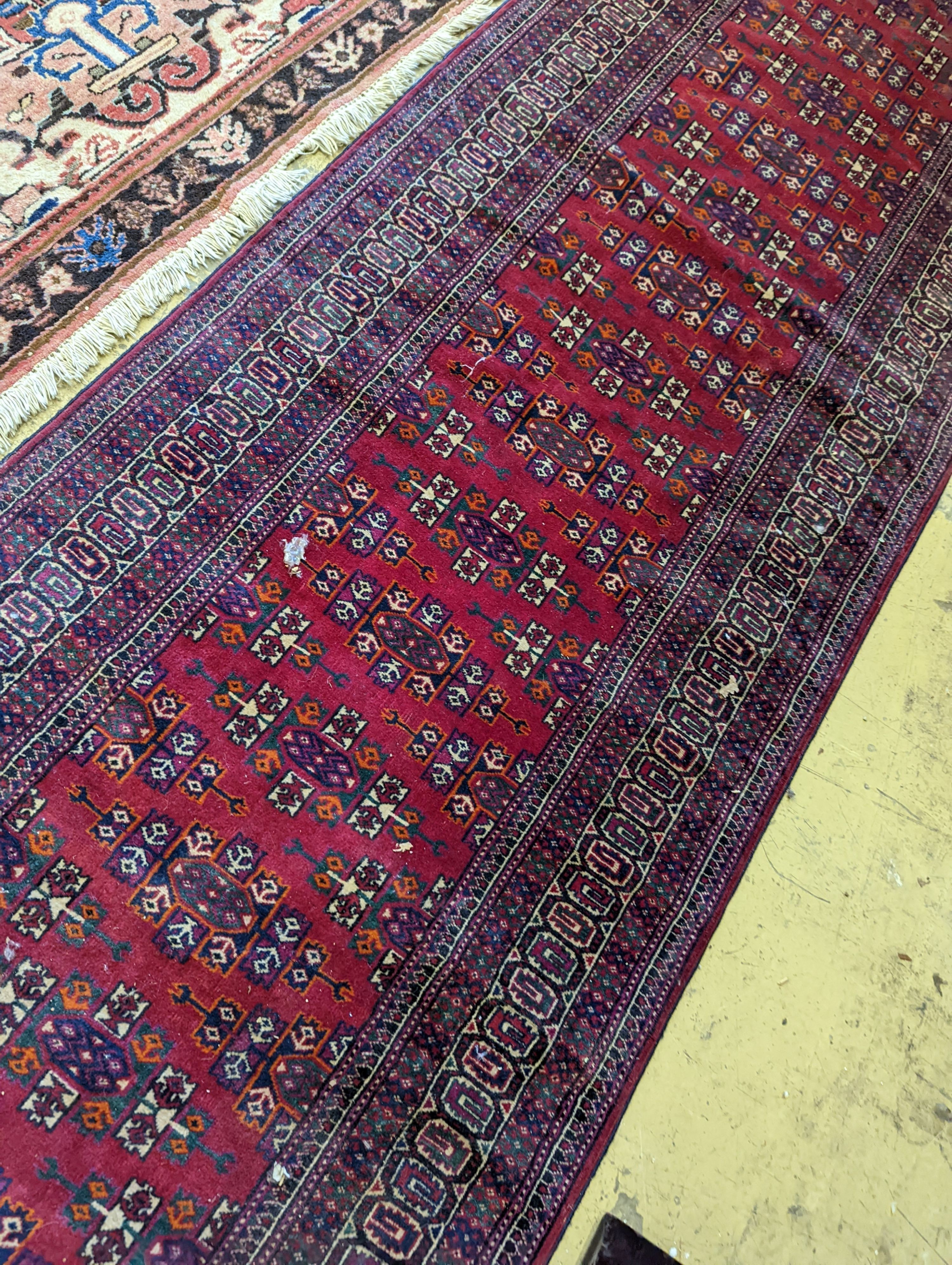 A Bokhara burgundy ground runner, 276 x 88cm